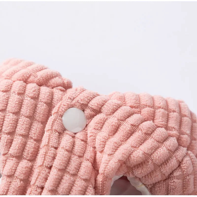 Pink ribbed corduroy dog vest with metal leash ring and bear emblem tag, sizes XS to XXL.