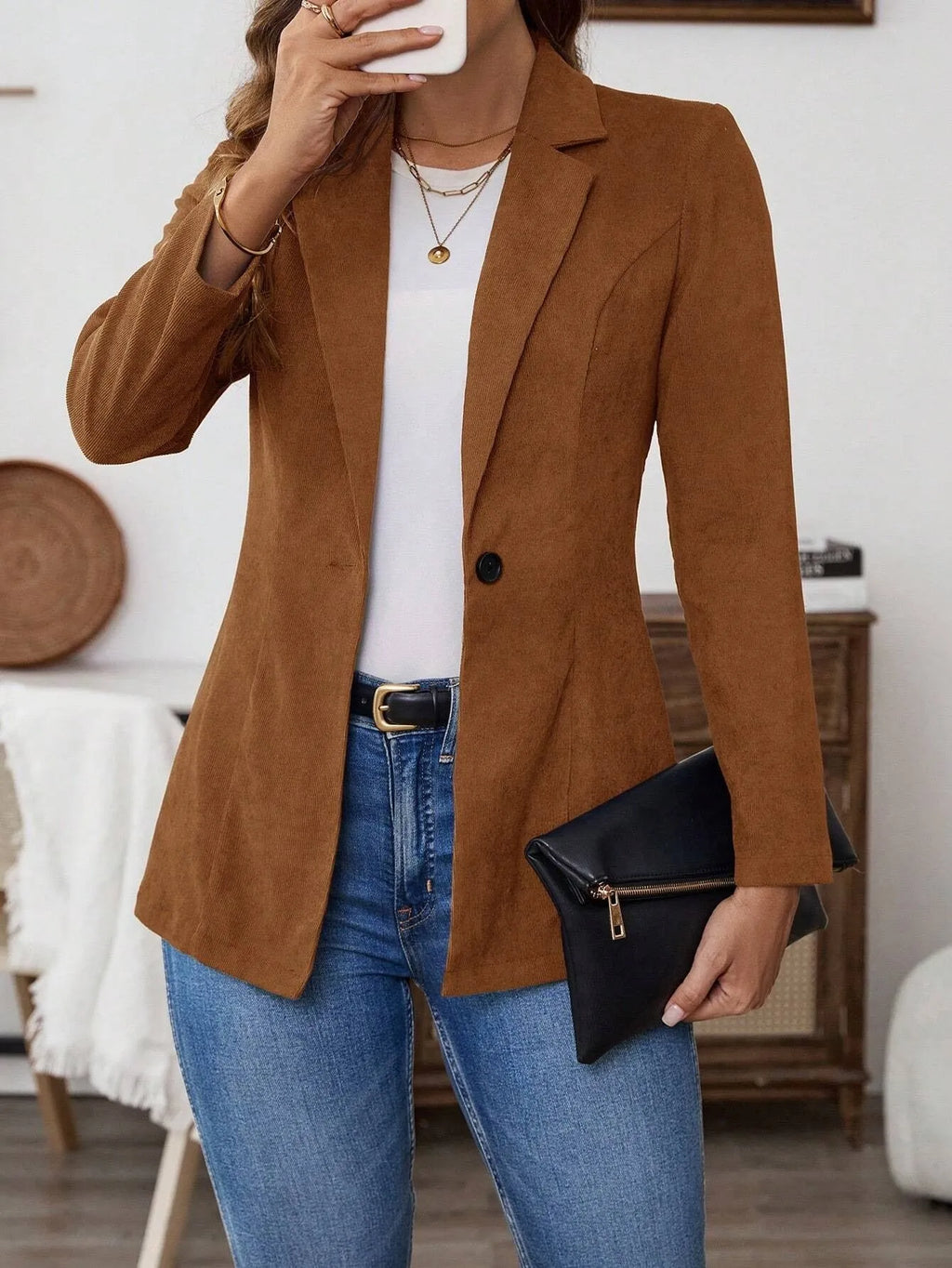 Brown single-breasted leisure suit coat with lapel collar and long sleeves laid flat.