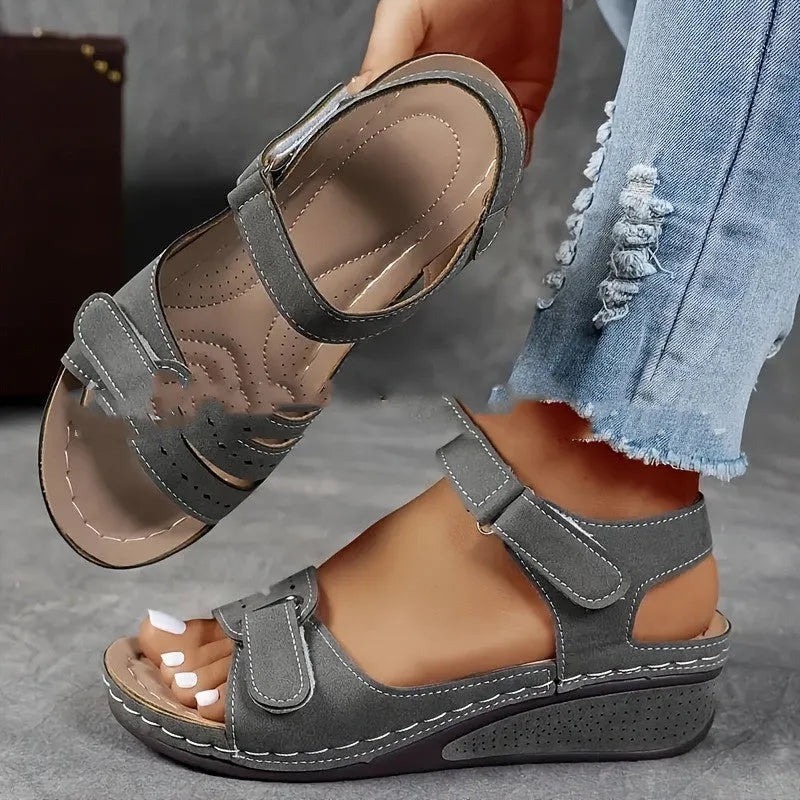 Women's beige plus size sandals with a thick composite sole and an adjustable Velcro strap fastener.
