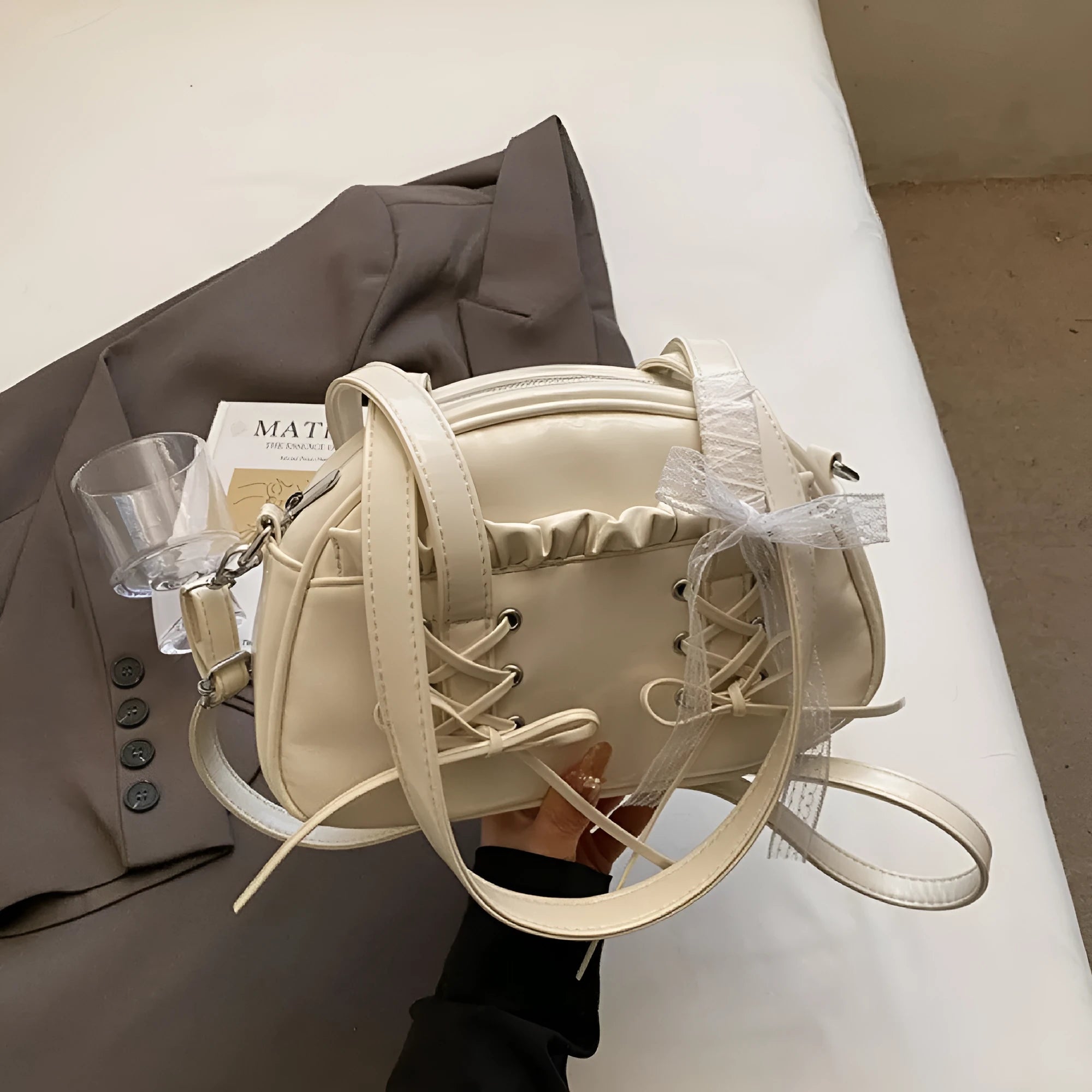 Women's casual PU shoulder handbag with a large bandage bow detail and phone compartment.