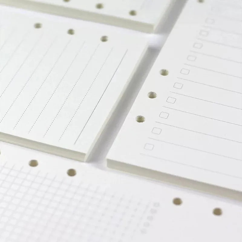 A5 6-hole loose-leaf refill with dot matrix ruling, 40 sheets of Daolin paper, displayed on a desk beside a ring binder