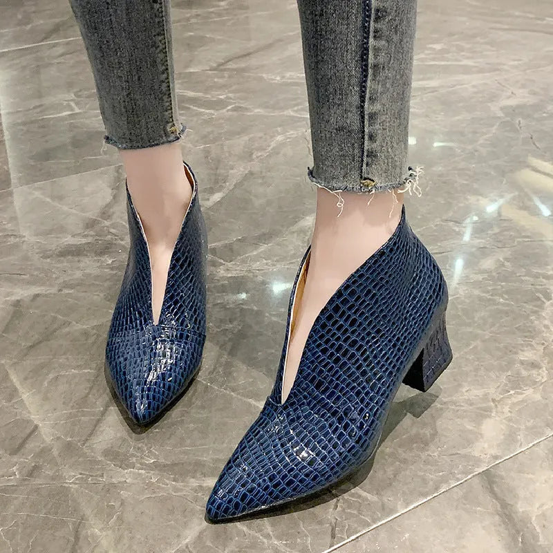 Women's black ankle boots with V-cut design, embossed texture, and chunky heel