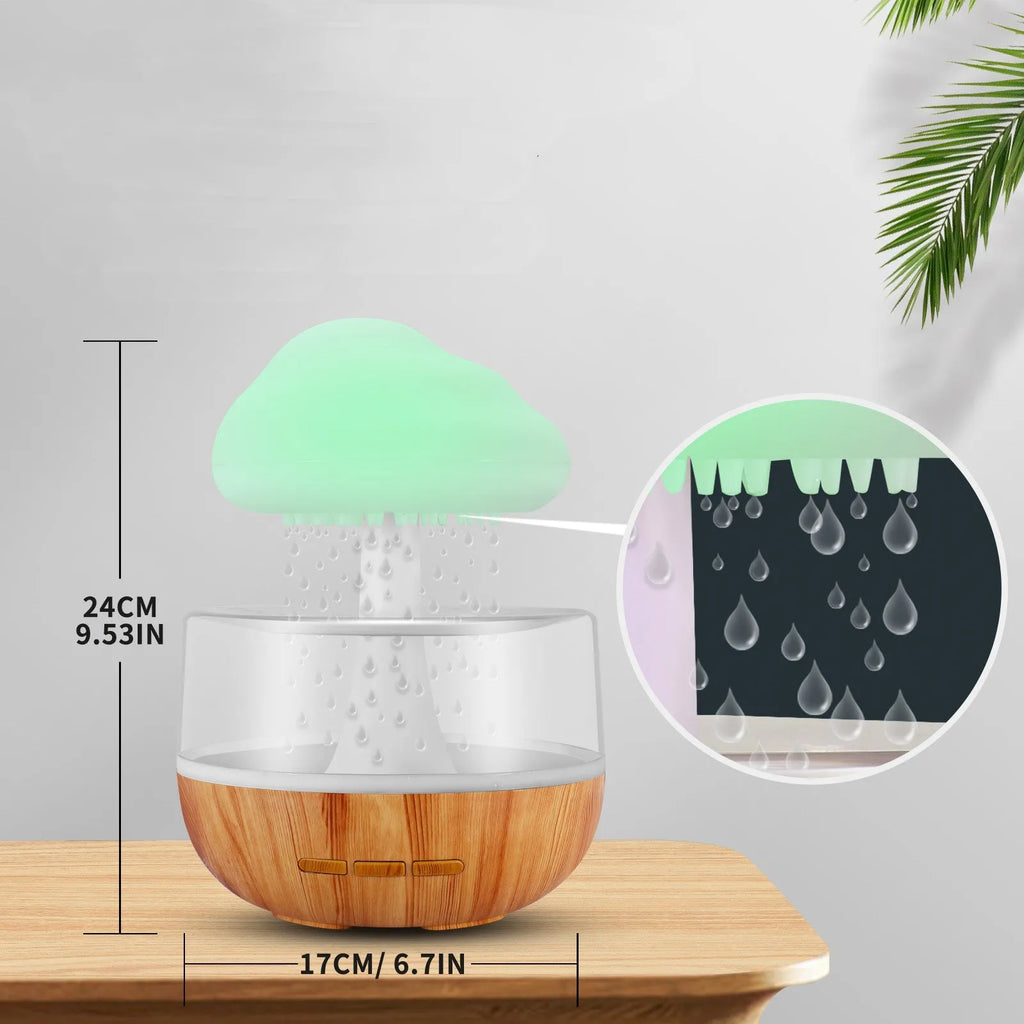 White cloud-shaped humidifier with LED night light and water droplet effect on a table.