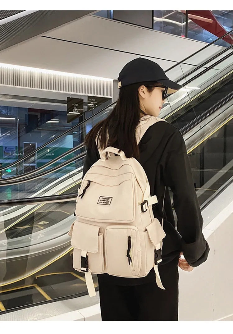 Black or white nylon student backpack with computer compartment measuring 31x12x41cm