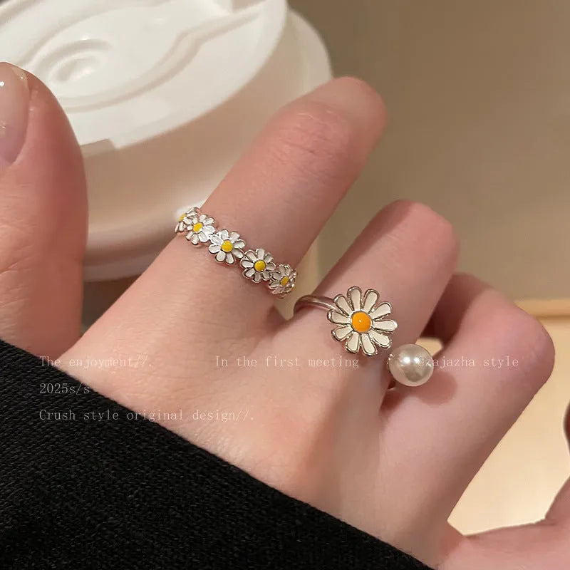 Women's copper opening ring with a sweet twin daisy design and pearl accent on a white background.