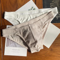 Men's solid colour pure cotton triangle underwear briefs on a mid waist, shown in apricot and black colour options.