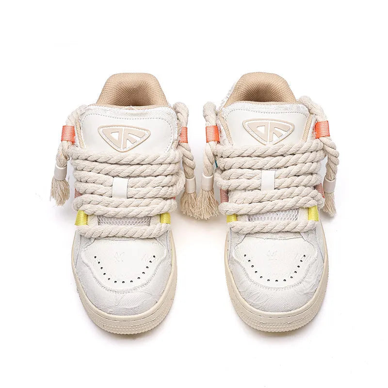 Creamy white low-top retro skateboard shoes with lace-up front and platform sole.