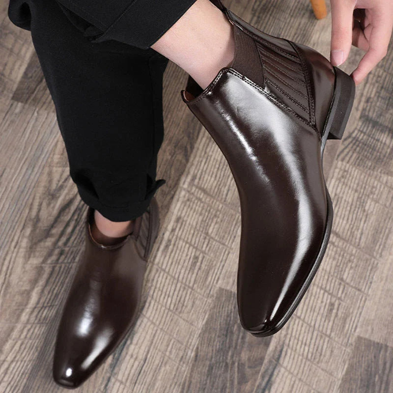 Stylish pointed-toe Chelsea boots for men in black and brown colors, featuring a square heel and sleek, British-inspired design.