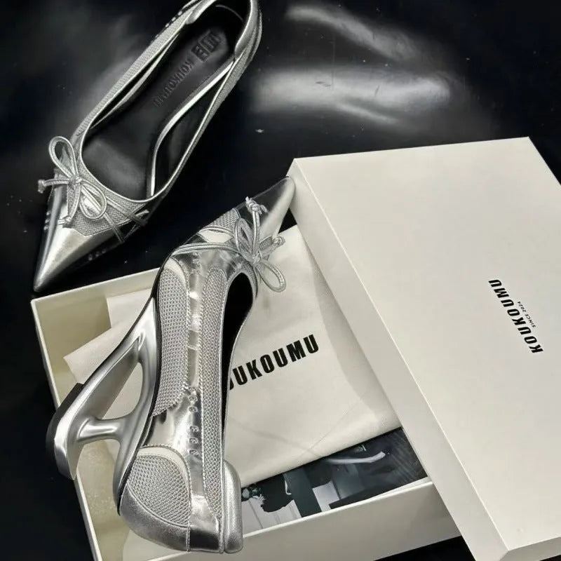 Black women's pointed toe Mary Jane shoes with a floating shaped heel and slip-on design.