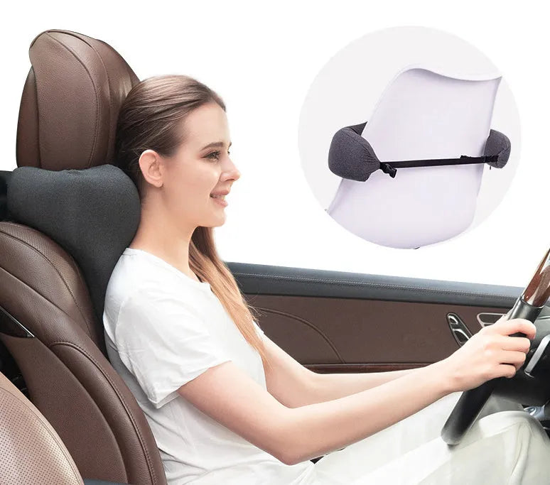 Dark grey car neck memory pillow on a headrest showing its simple rectangular shape.