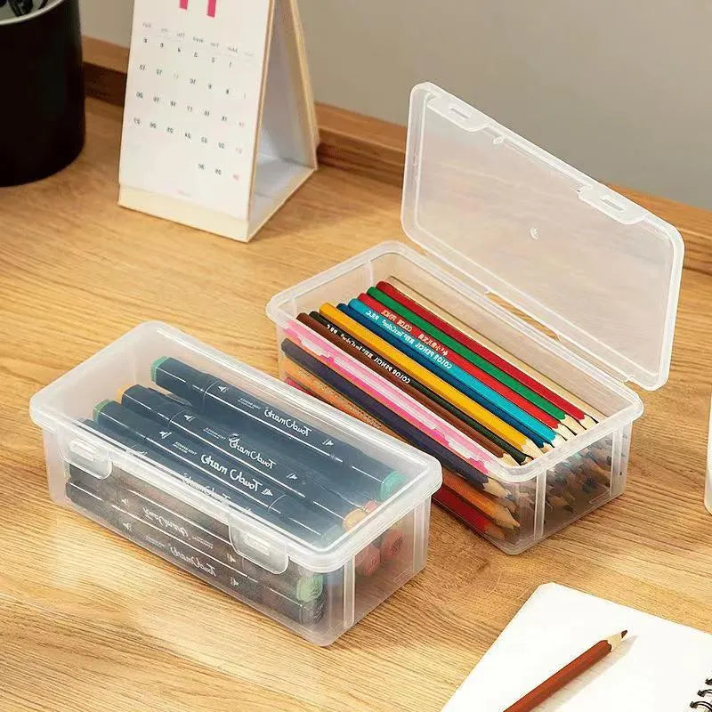 Transparent plastic pencil storage box for stationery organisation with visible drawing supplies inside