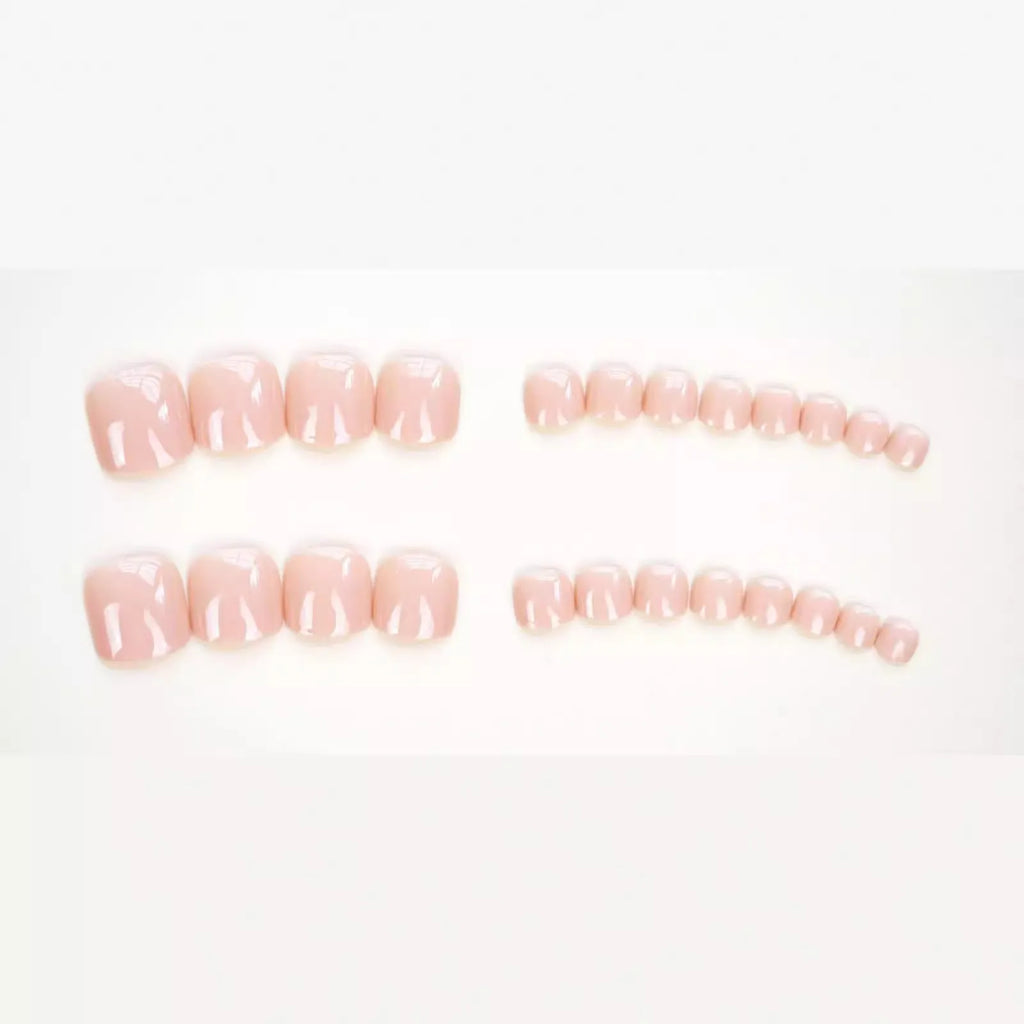 Plastic toenail stickers in skin colour with adhesive glue bottle on white background