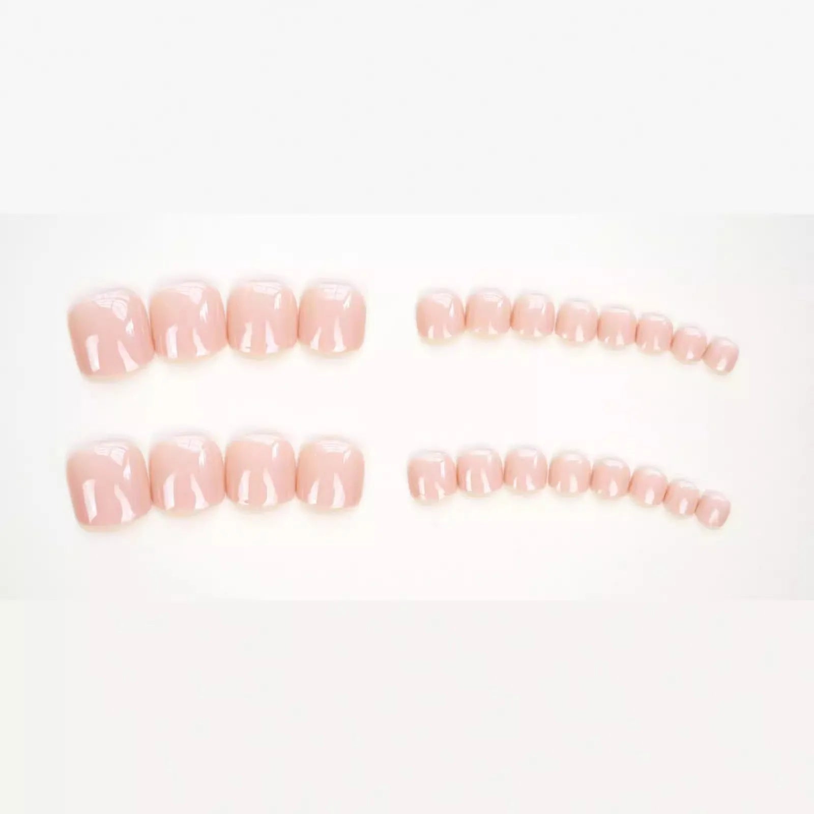 Plastic toenail stickers in skin colour with adhesive glue bottle on white background