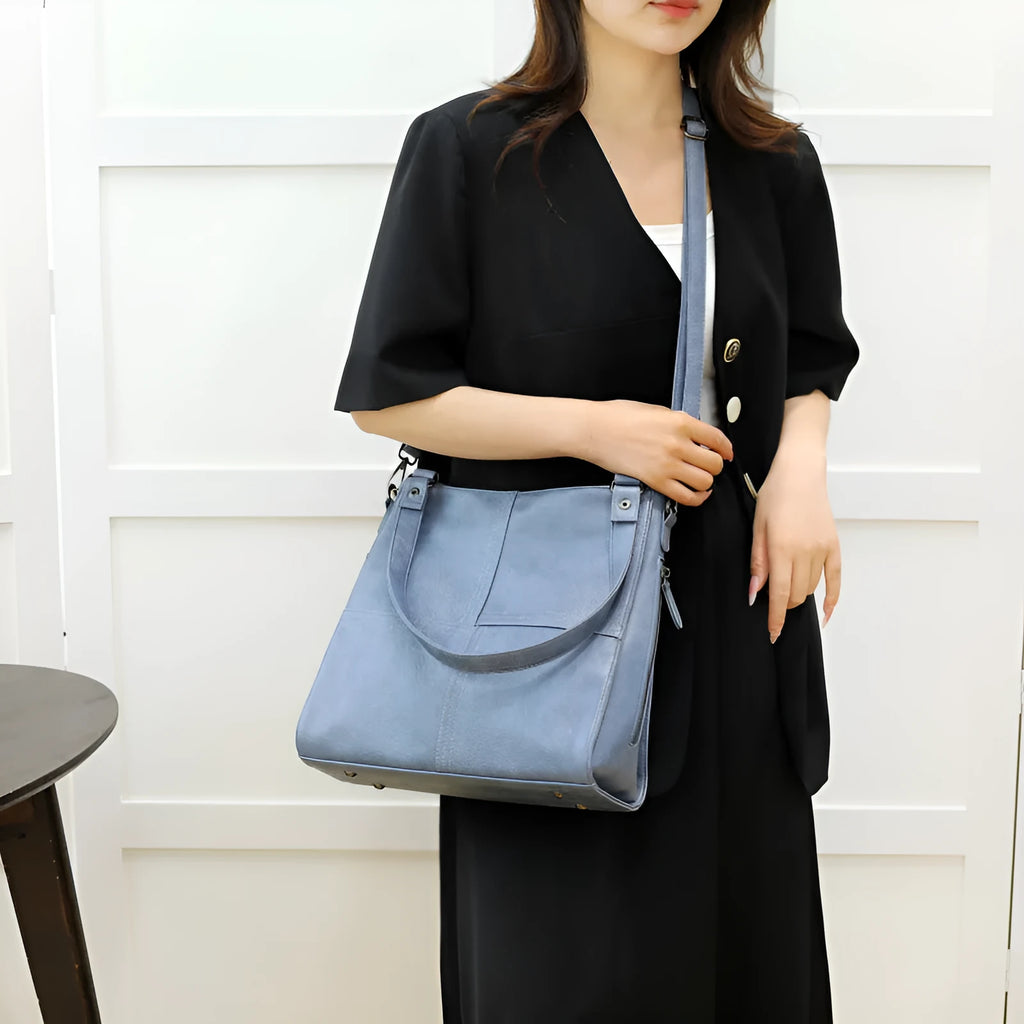 Soft PU retro style crossbody handbag in barrel shape showing pocket sandwich design.