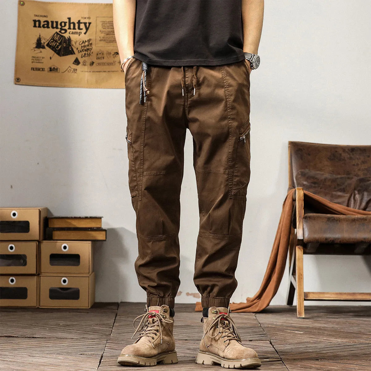 Men's khaki cotton harem pants with tapered ankle cuffs and a loose fit, shown laid flat.