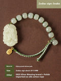 Hetian jade Rabbit charm bracelet on a red rope with a small silver blessing card.
