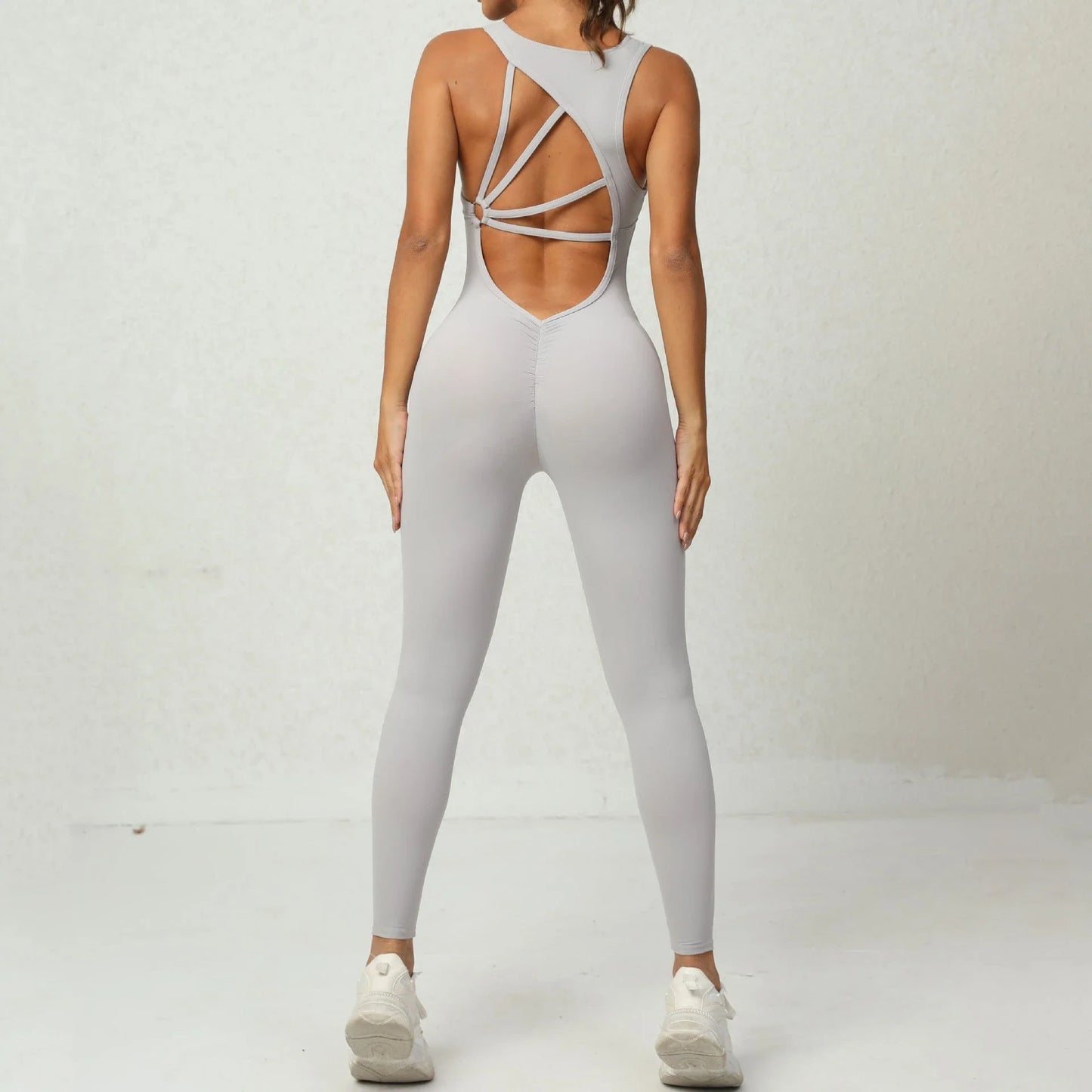 Sleeveless yoga jumpsuit with v-shaped back design, available in various colors and sizes