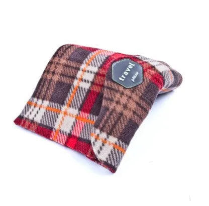 Black U-shaped convex travel neck pillow filled with cotton, shown on a grey background.