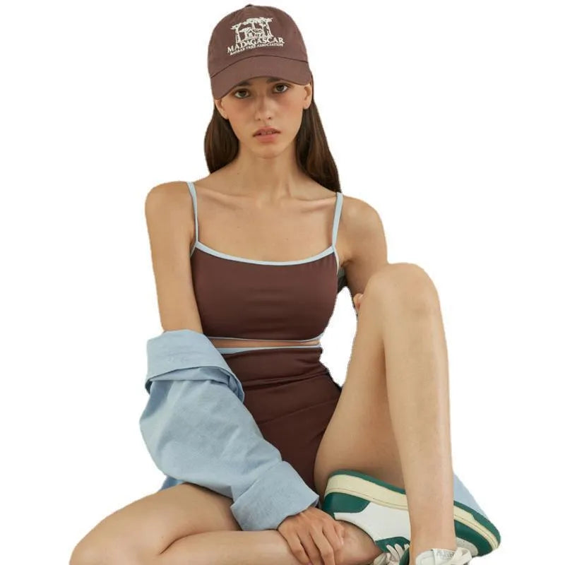 Brown triangle one-piece swimsuit for women on a mannequin, showing front design.