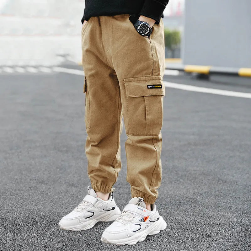 Boys' casual cotton trousers in army green, shown laid flat with size label visible.
