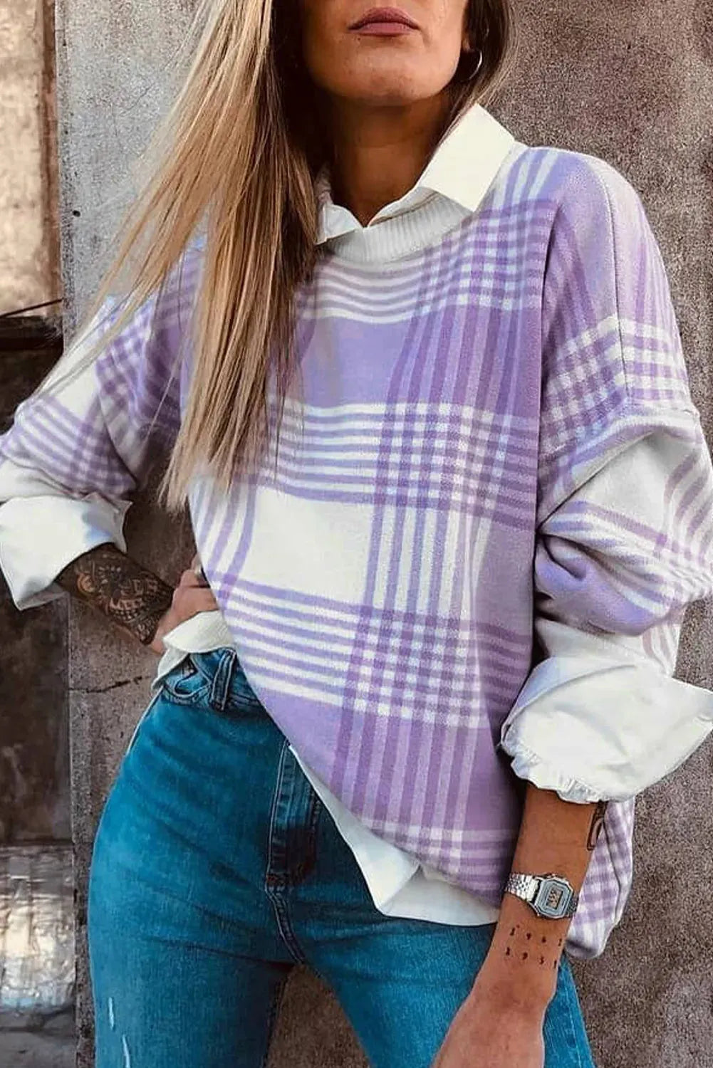 Lilac plaid print loose sweater with ribbed cuffs and hem on a hanger.