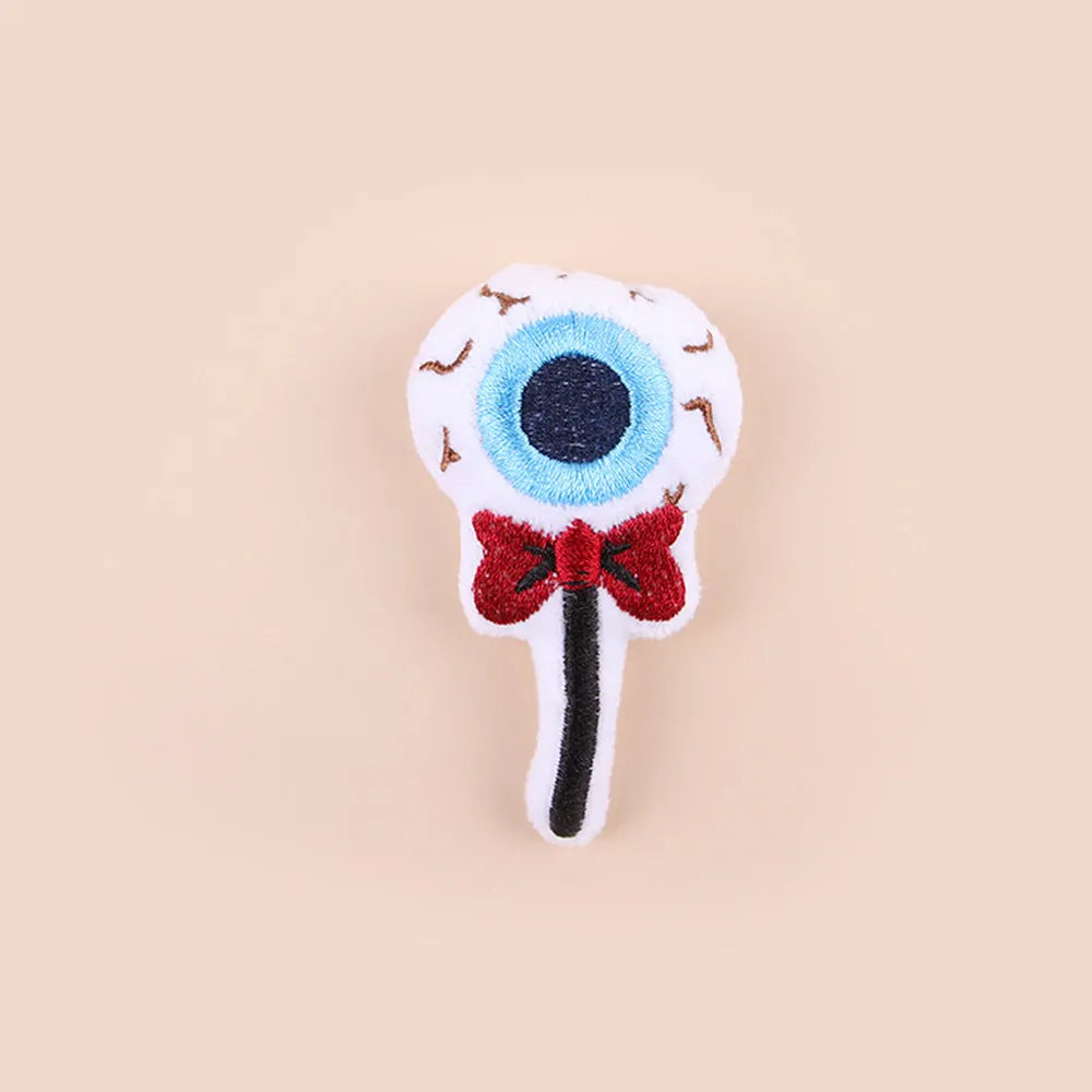 Plush cat teaser wand with candy-shaped attachment for interactive play