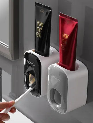 Black wall-mounted automatic toothpaste holder with toothbrush storage and suction cup mounting
