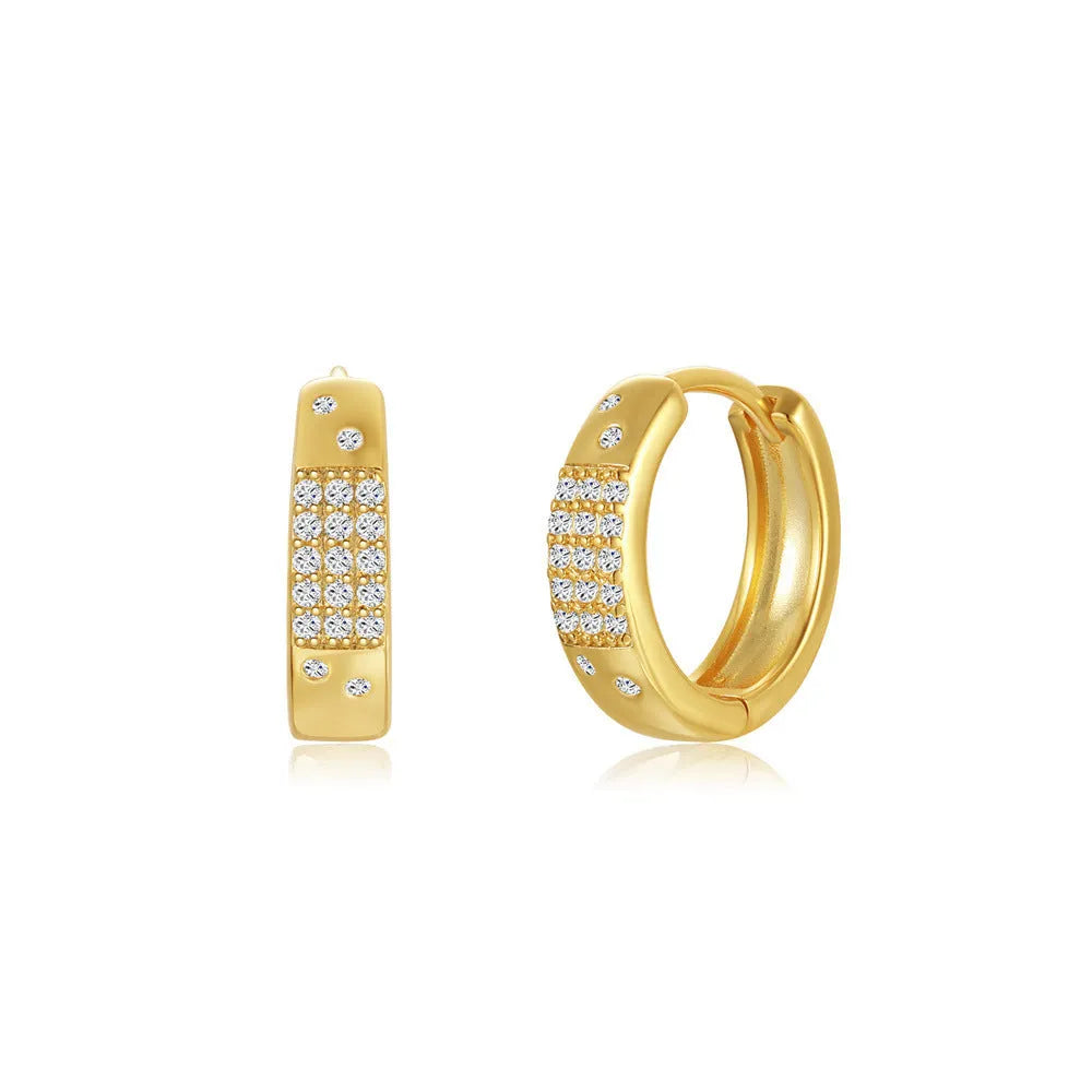 A pair of round geometric brass clip earrings with a gold electroplated finish on a white background.