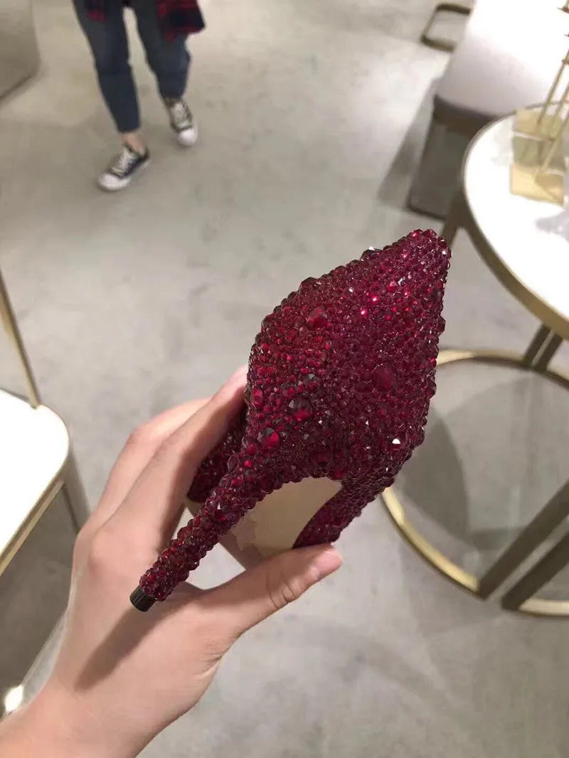 Gold women's pointed toe stiletto heels with sequin and rhinestone decoration on a shallow mouth.