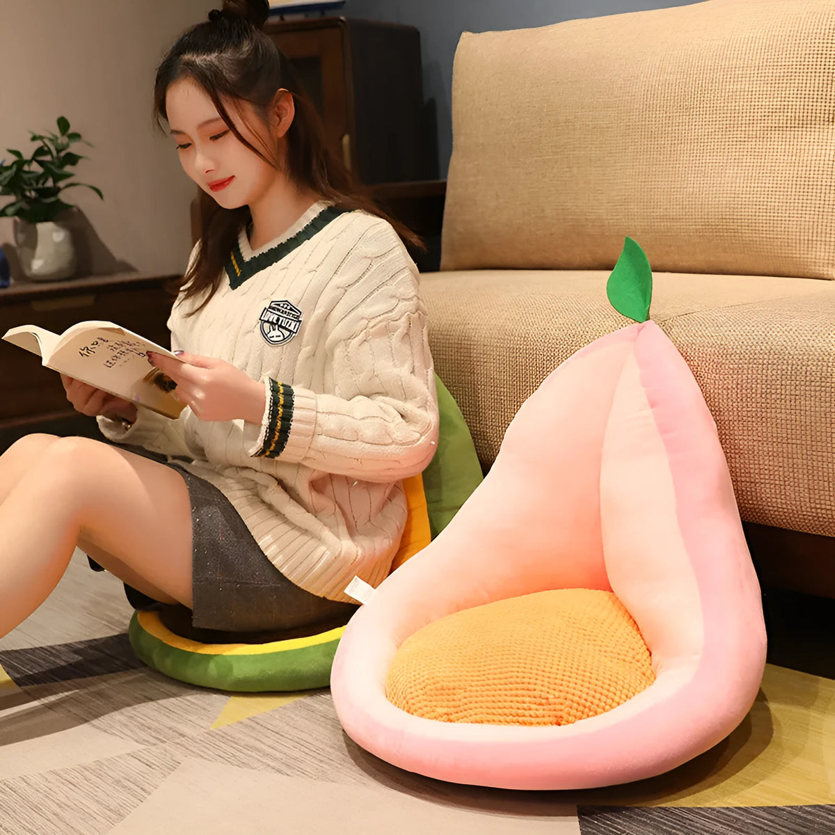 Kawaii plush fruit cushion in avocado colour on a chair, 50x48x45cm, with soft textured cover and non-slip base