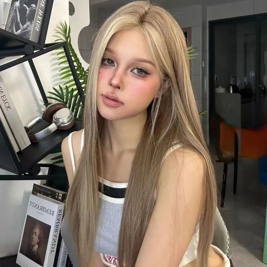 A woman's golden brown gradient forehead lace wig with a centre-parted style.
