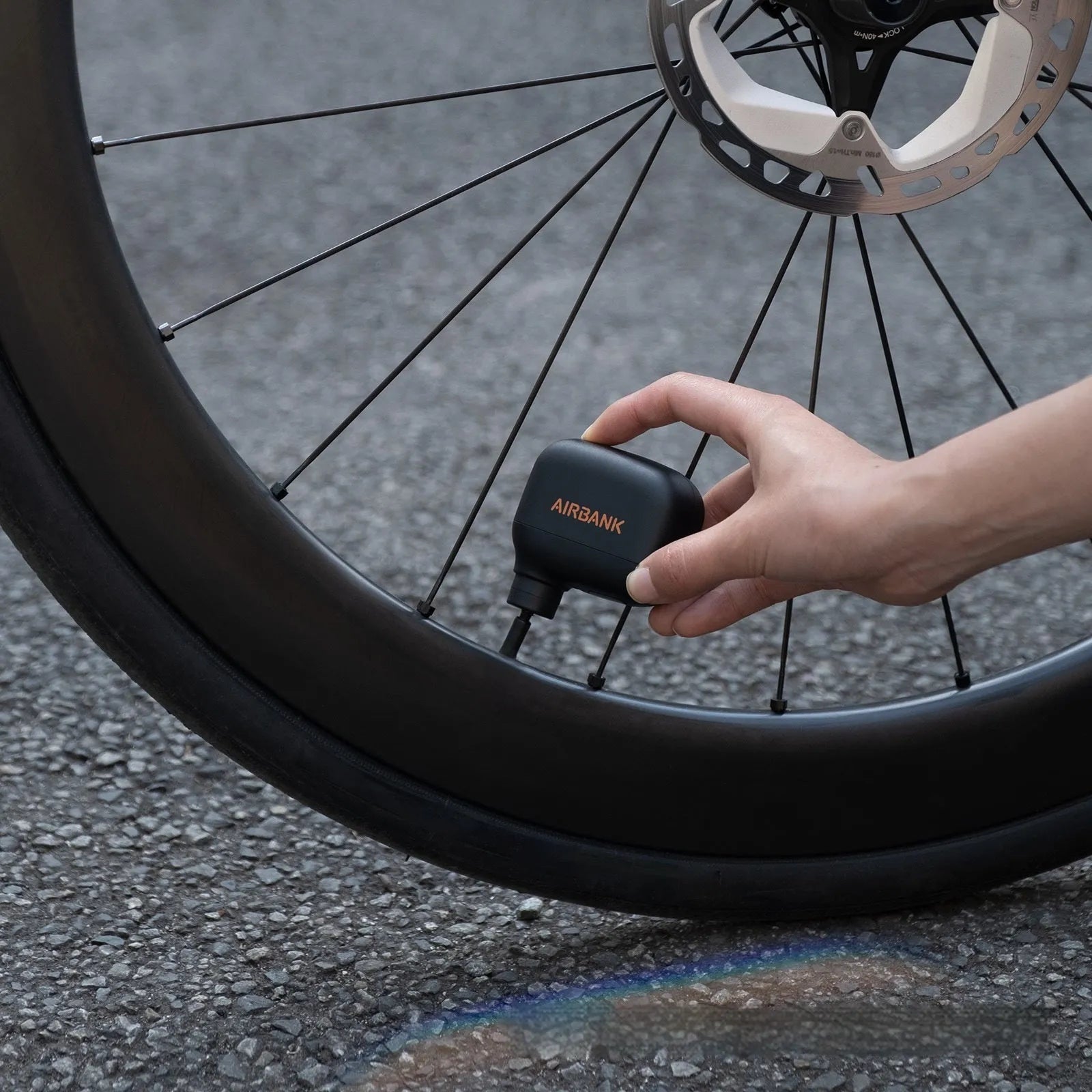 Black electric bicycle tyre inflator pump with USB charging cable and waterproof storage bag