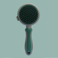 Green and pink double-sided cat grooming brush with plastic bristles, rubber massage pins, release button, and flea comb
