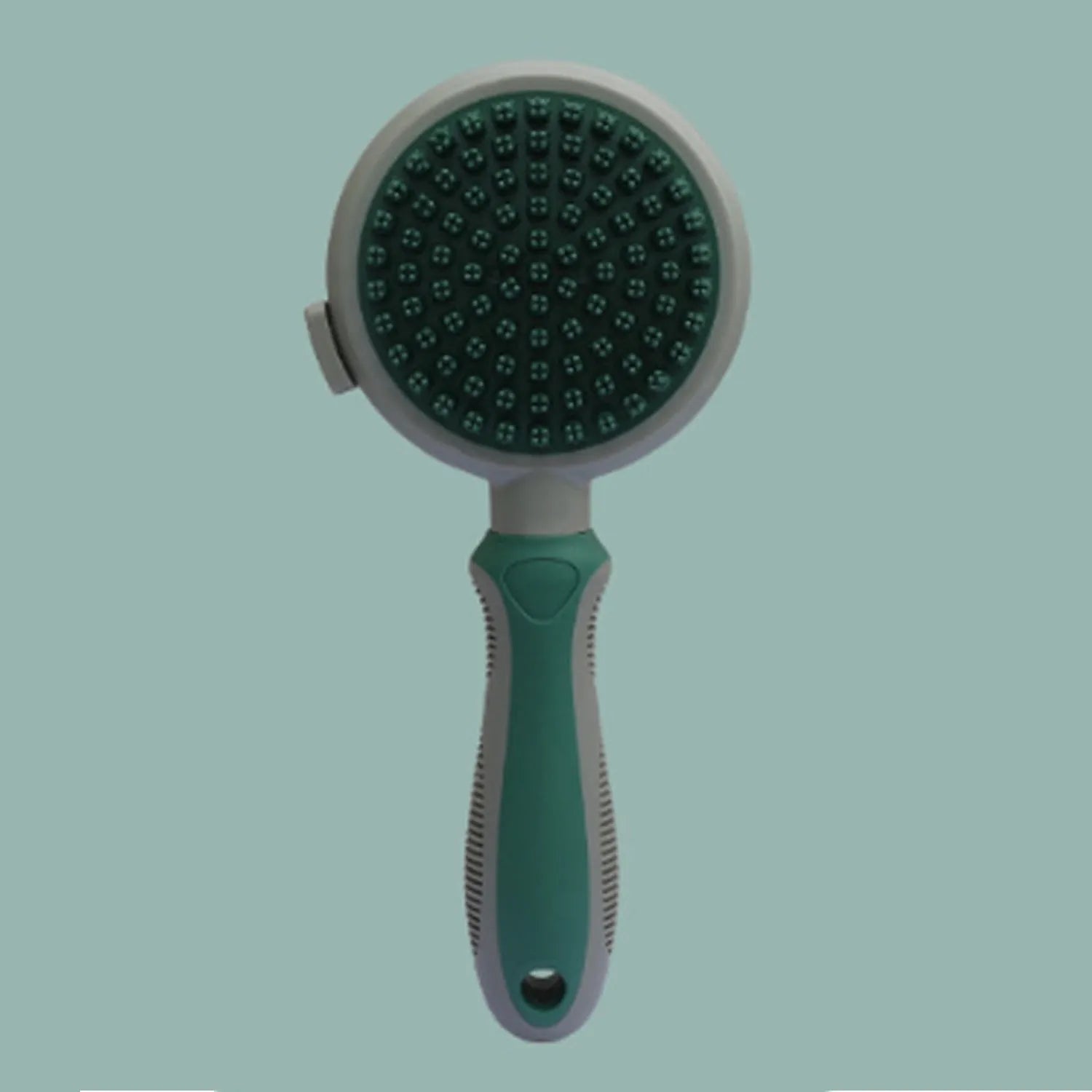 Green and pink double-sided cat grooming brush with plastic bristles, rubber massage pins, release button, and flea comb