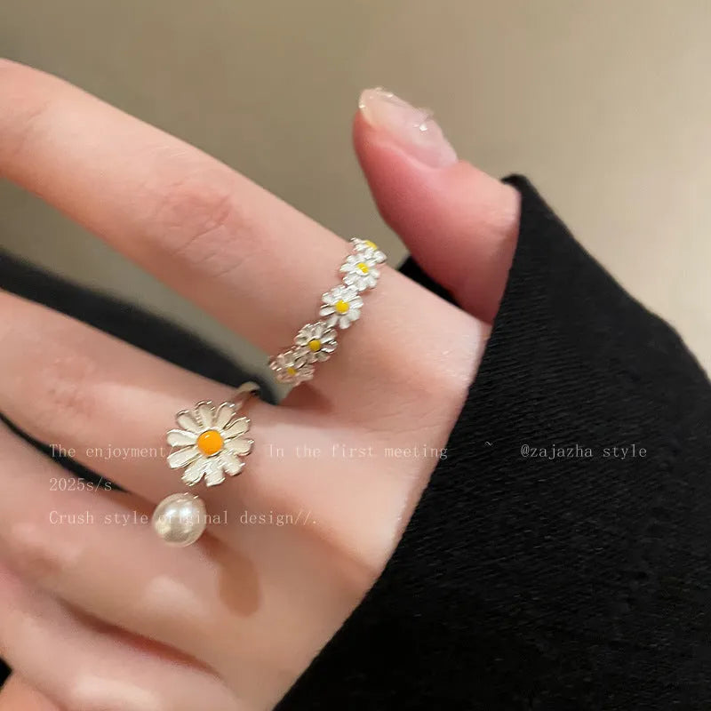 Women's copper opening ring with a sweet twin daisy design and pearl accent on a white background.
