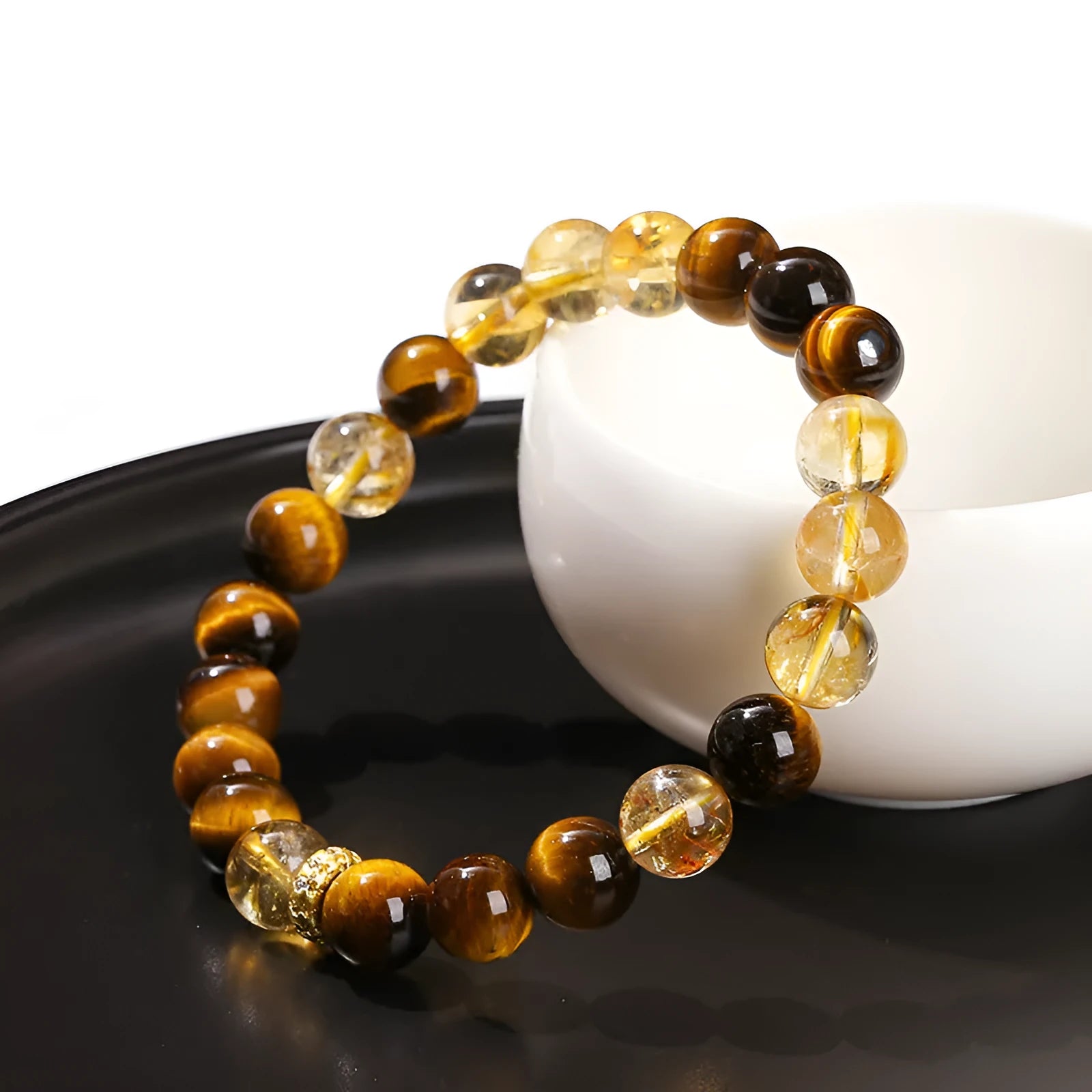 Women's geometric bracelet with natural yellow tiger stone and yellow tower crystal beads on wrist.