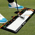 Black neoprene golf swing posture correction training pad on a green surface.