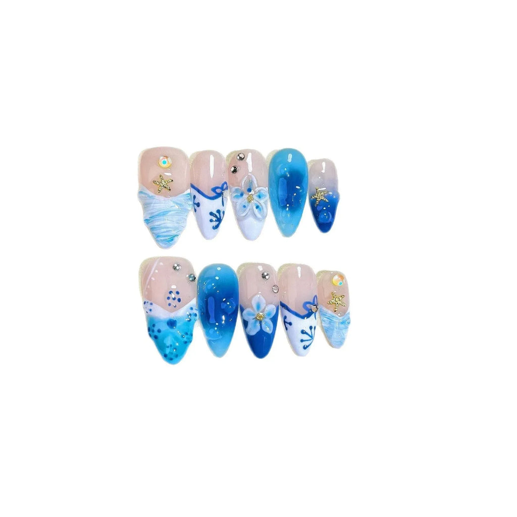 Blue carved designs on transparent fake nails showing summer ice aesthetic