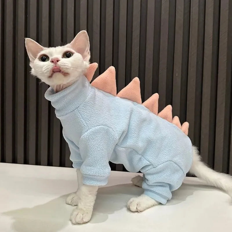 Sphynx cat wearing dinosaur costume with fleece material and tail spikes