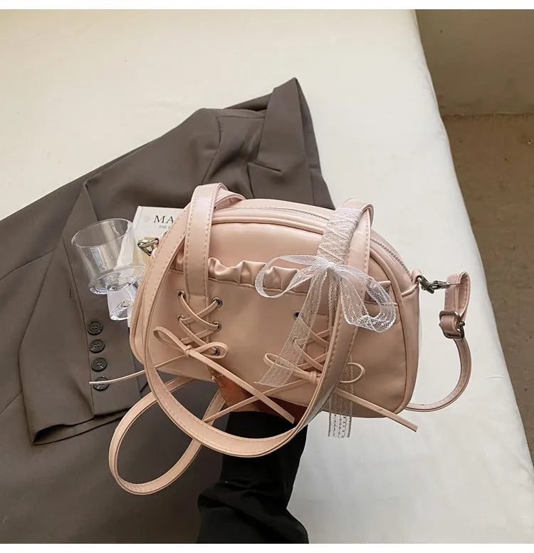 Women's casual PU shoulder handbag with a large bandage bow detail and phone compartment.