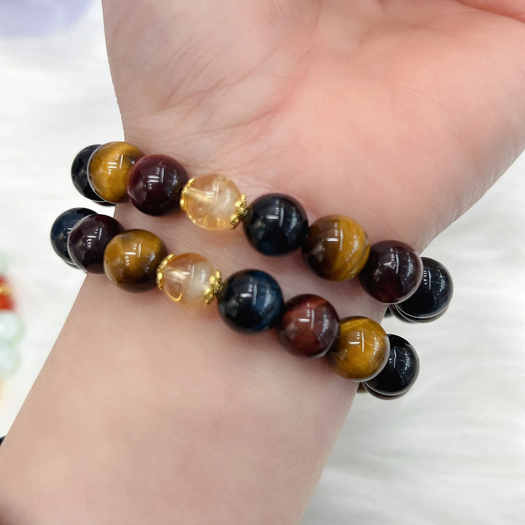 Natural golden-brown tiger eye gemstone bead bracelet with an adjustable clasp on a wrist.