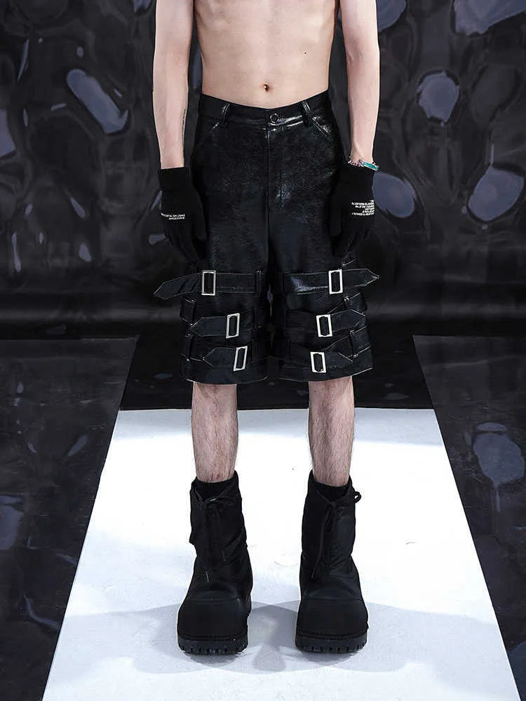 Black men's PU leather cropped shorts with leather ring detailing on a model