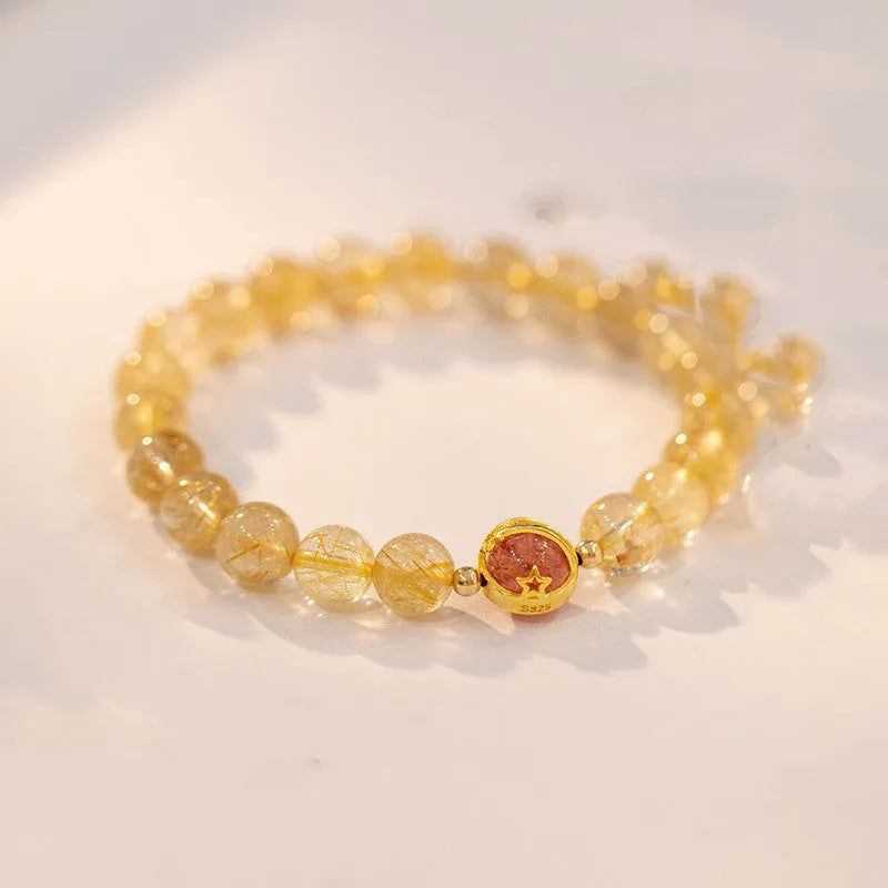 Gold rutilated quartz crystal bracelet with diamond-cut beads in a Korean-style design.