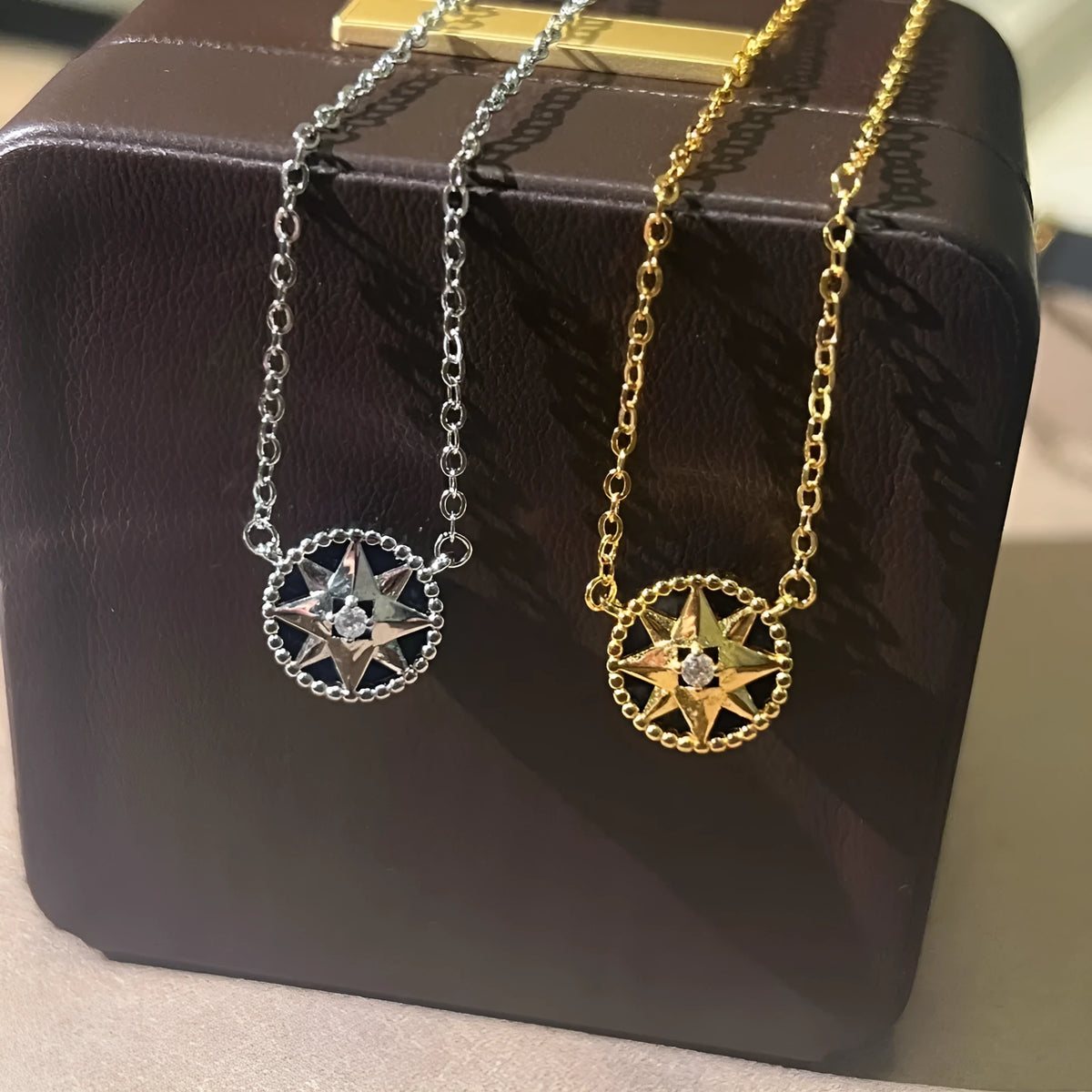 Women's compass necklace with round black agate inlay, geometric pendant, and curb chain in gold or platinum colour
