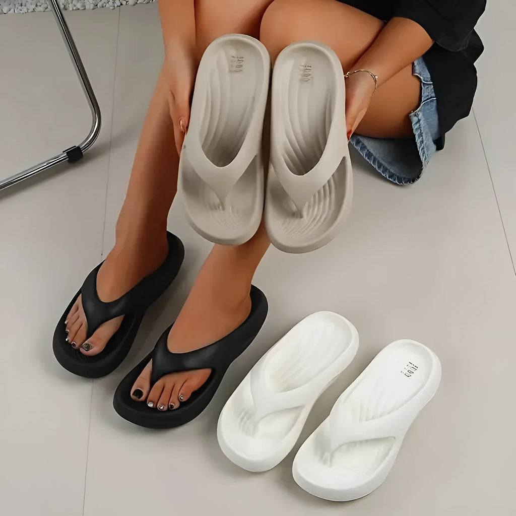 Women's thick-soled flip flops with non-slip textured soles in black, white, and grey colour options