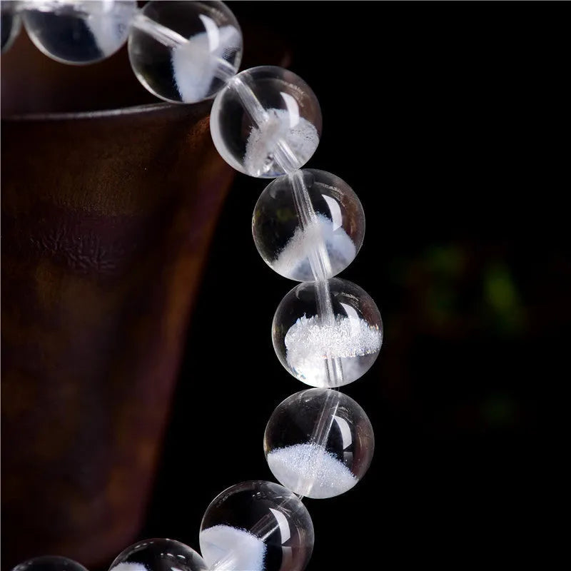 Women's natural white ghost bracelet with a white crystal pyramid charm and ruyi design elements.