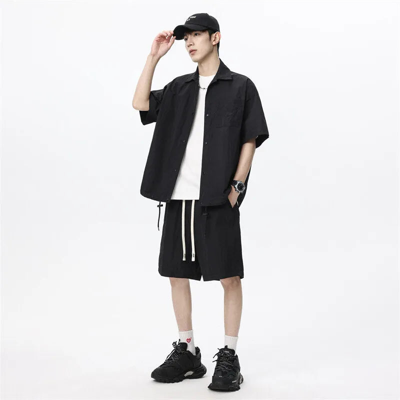 Man wearing a loose dark grey hemp-blend shirt and matching shorts casual two-piece set.