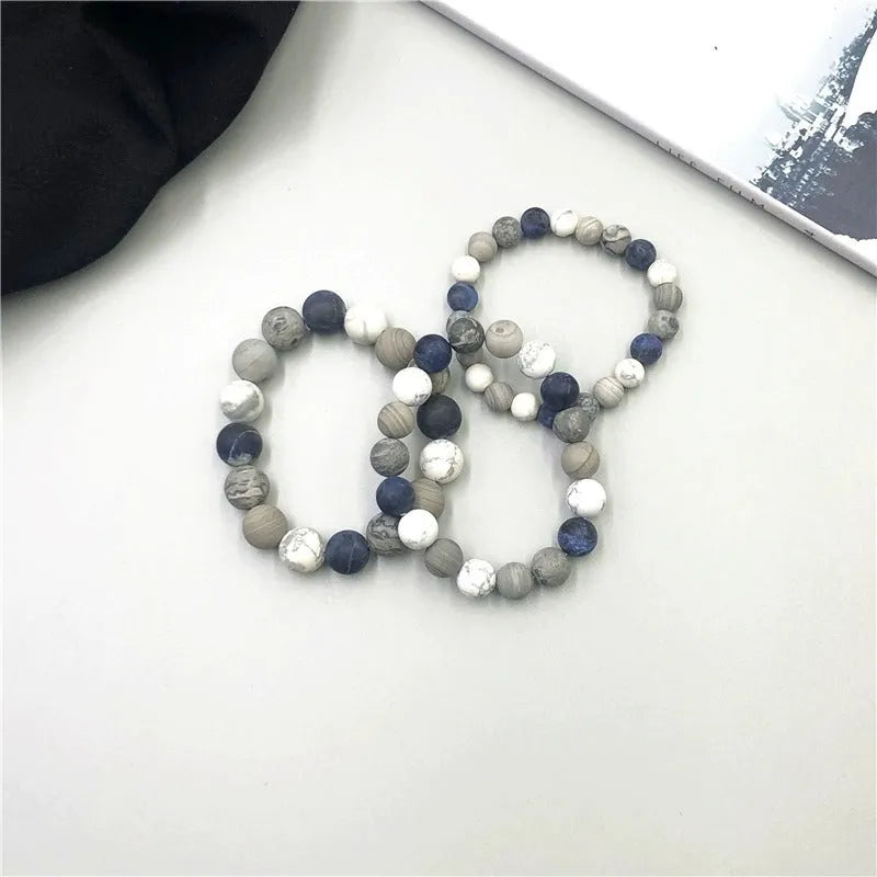 Handmade planet stone U-shaped bracelet with universe wind design on a wrist.