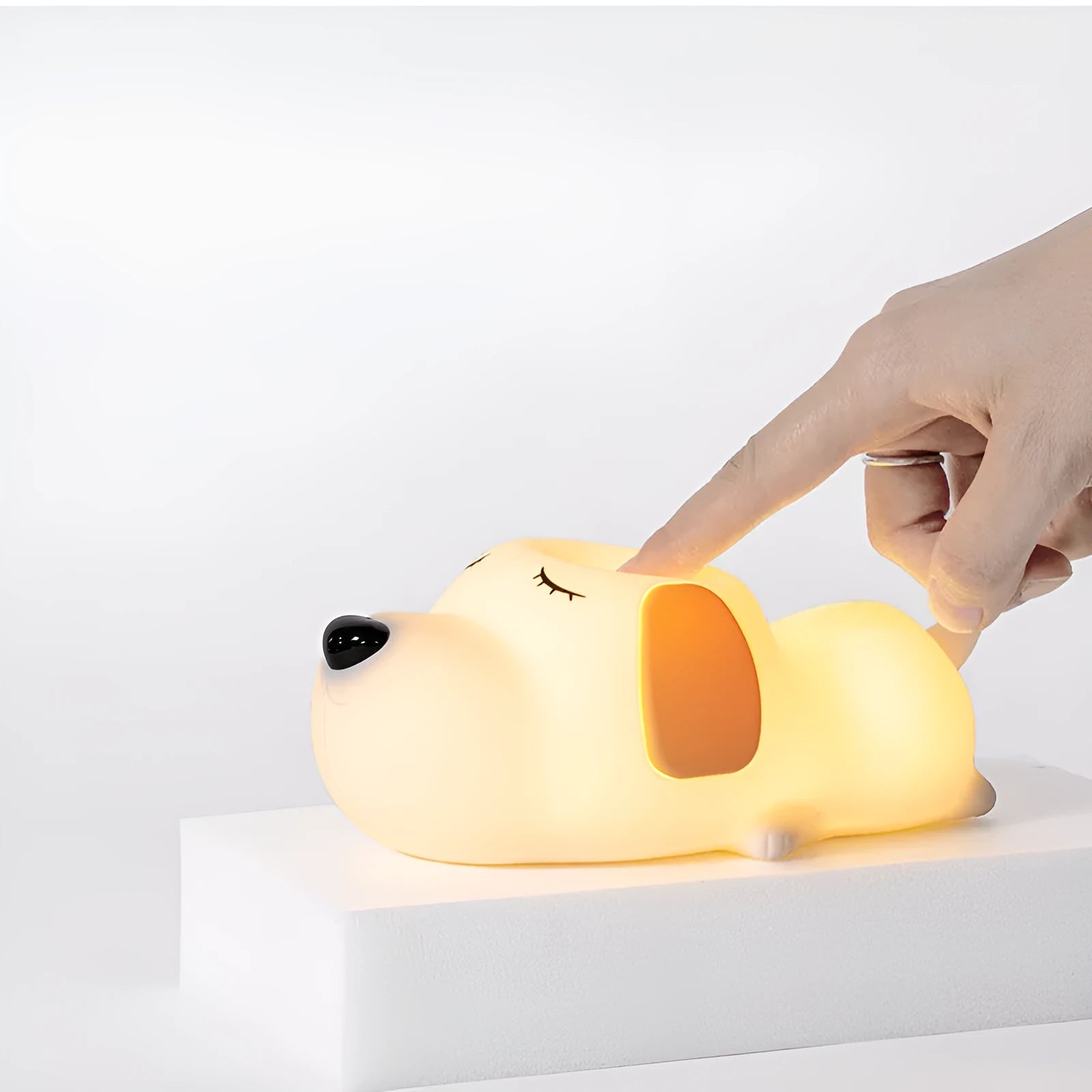A two-tone cartoon dog-shaped silicone night lamp with a USB charging port.