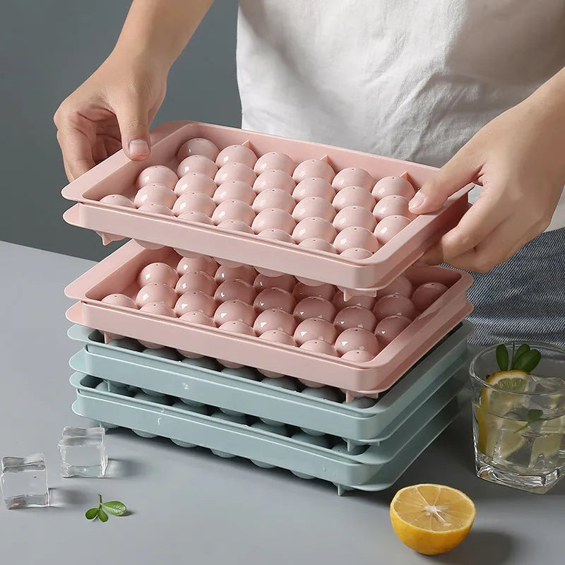 Sky blue and pink plastic round ice ball mould trays with 18 and 33 grids.